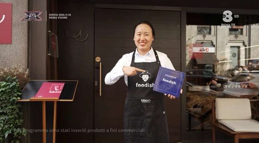 Lo staff di MU Dimsum con la targa di vincitore di Foodish davanti al ristorante di via Aminto Caretto a Milano